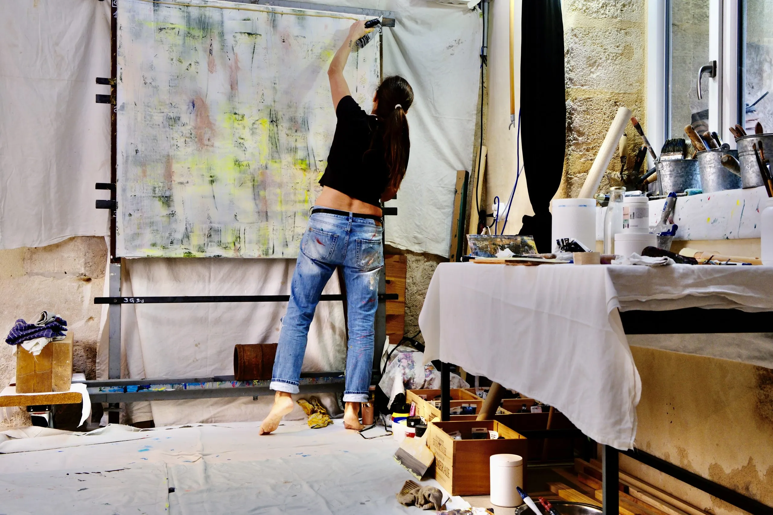 Véronique Massie’s studio: a large plate being worked on, the table and the jars of pigment
